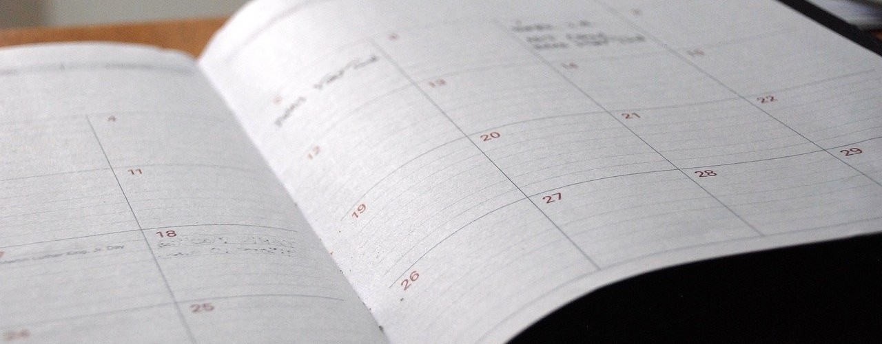 The photo shows a pocket calendar with notes entered on some days and on others not.