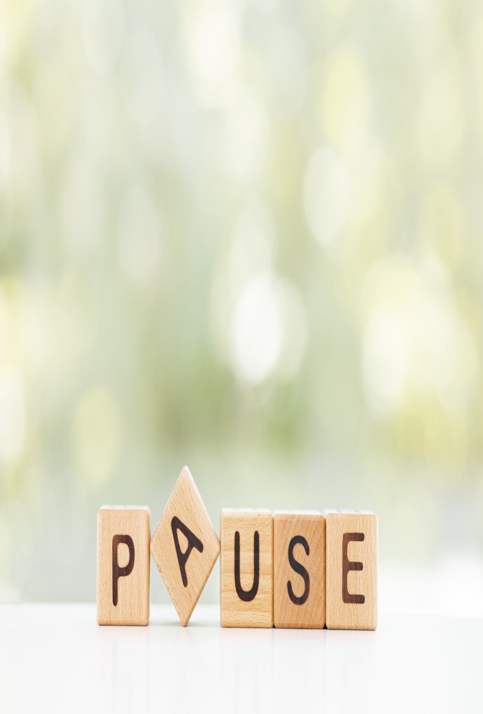 Wooden Blocks with the text: Pause on a green background