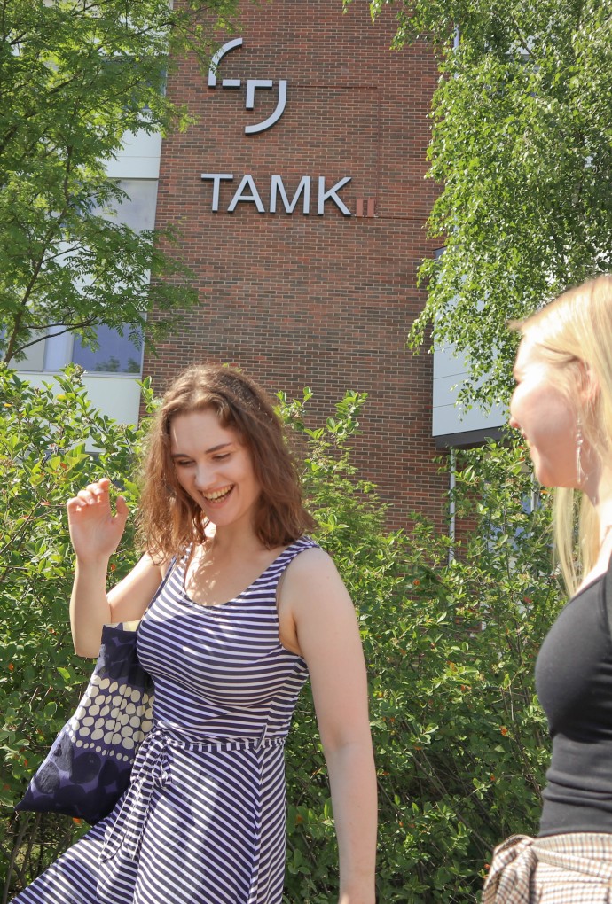 TAMK Campus with ambassadors - one male and two female students
