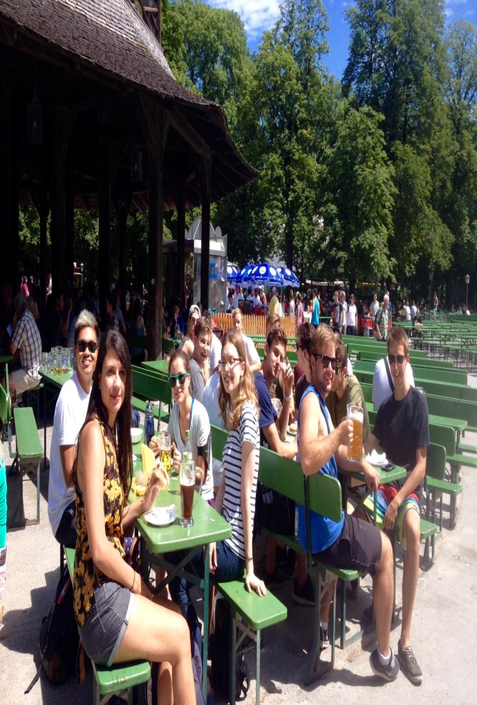 Students taking a break from the Munich Bike Tour in the beer garden, with drinks and food, on a sunny day