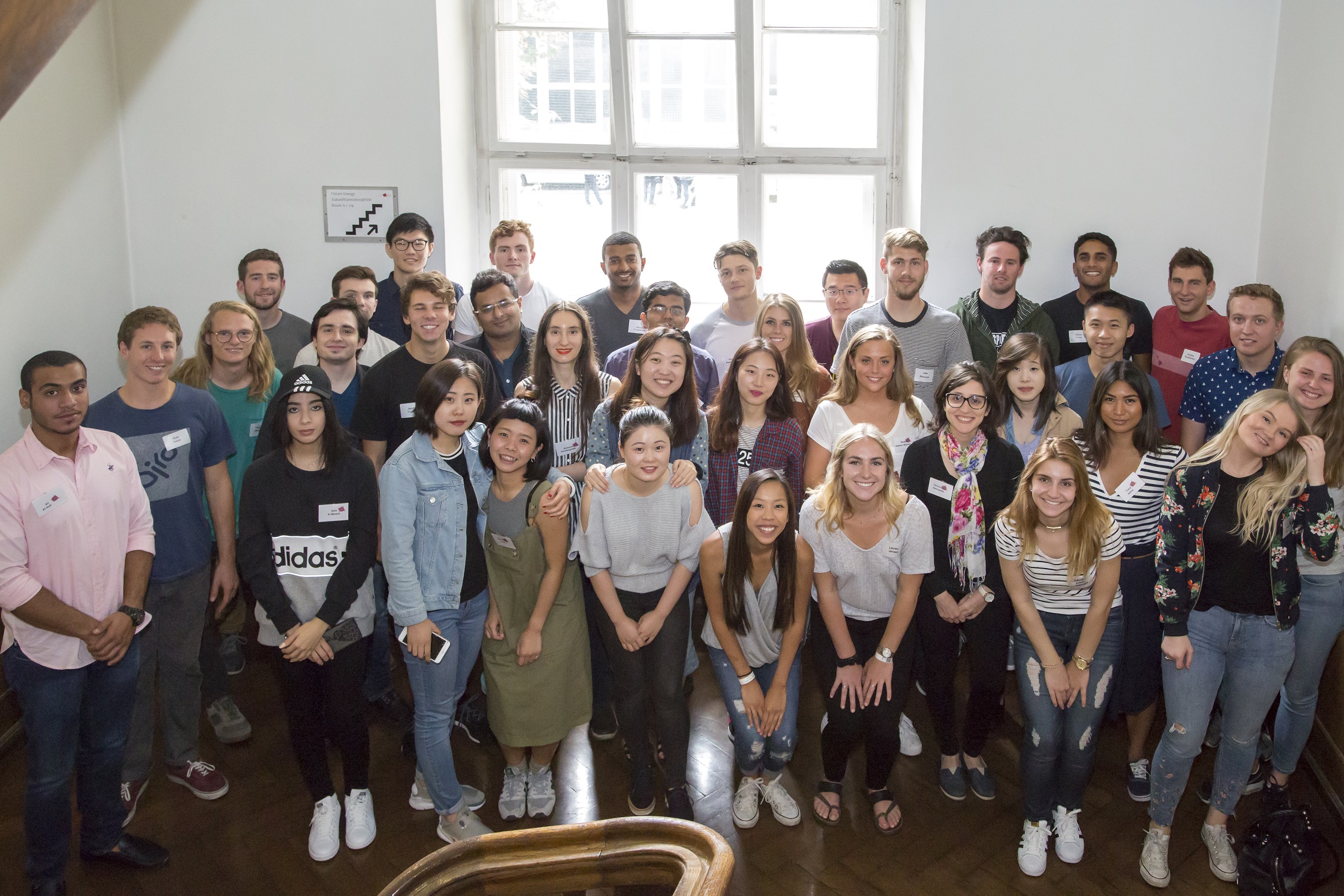 Group picture of the summer school students in the old building of the Munich University of Applied Sciences, smiling