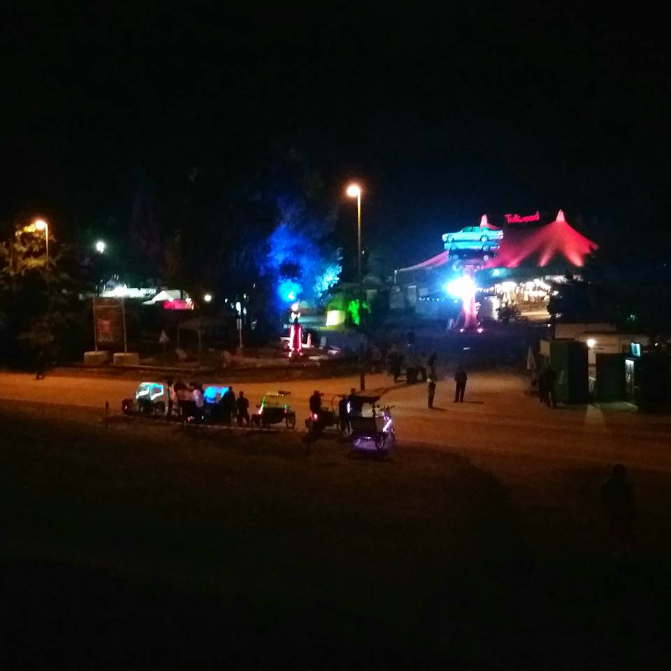 Image of the Tollwood Festival with lights and tents in the evening