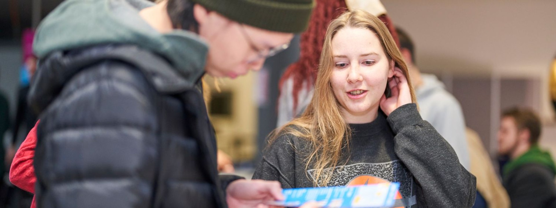Internationale Studierende der HM lesen Infomaterial 