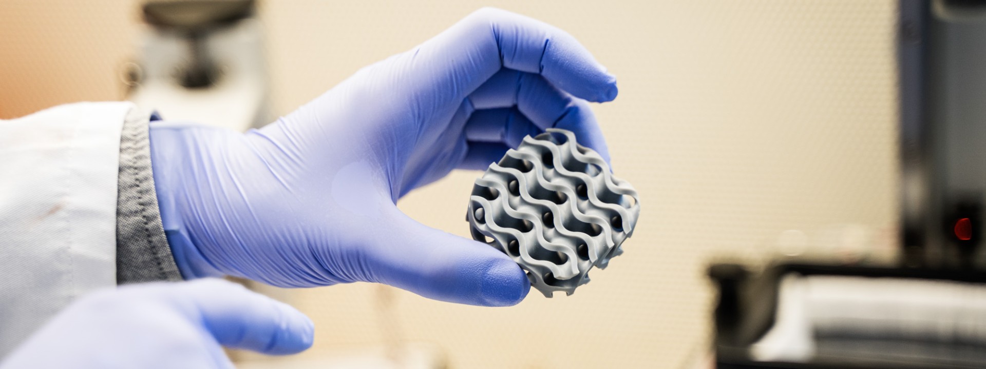 An HM researcher holds an object up to the camera