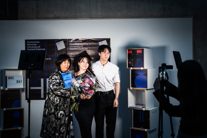 Absolventin mit ihrer Familie beim Festakt zu fünf Jahren MUC.DAI 