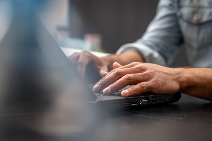 Hands on a laptop keyboard